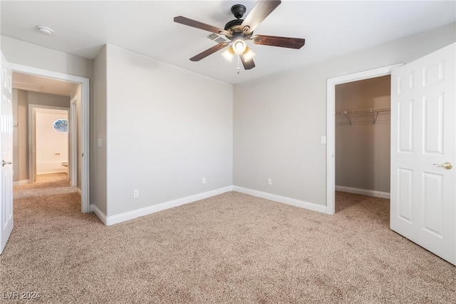 unfurnished bedroom featuring ceiling fan, a closet, and light carpet