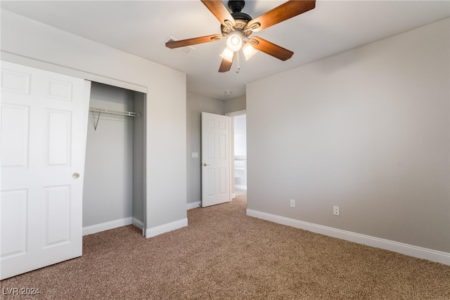 unfurnished bedroom with ceiling fan, a closet, and carpet