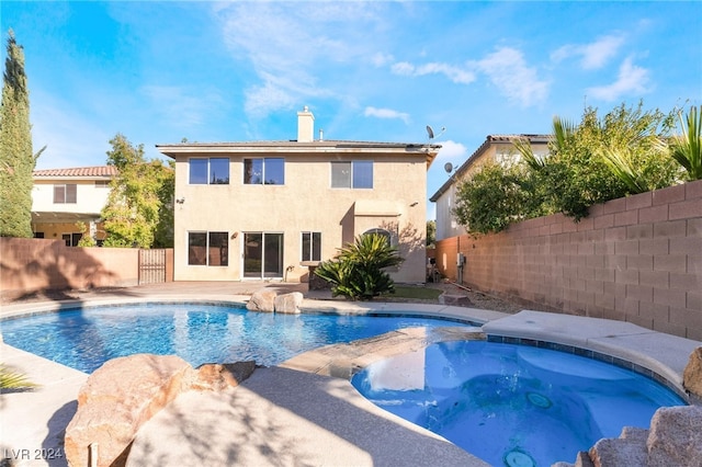 view of pool featuring an in ground hot tub