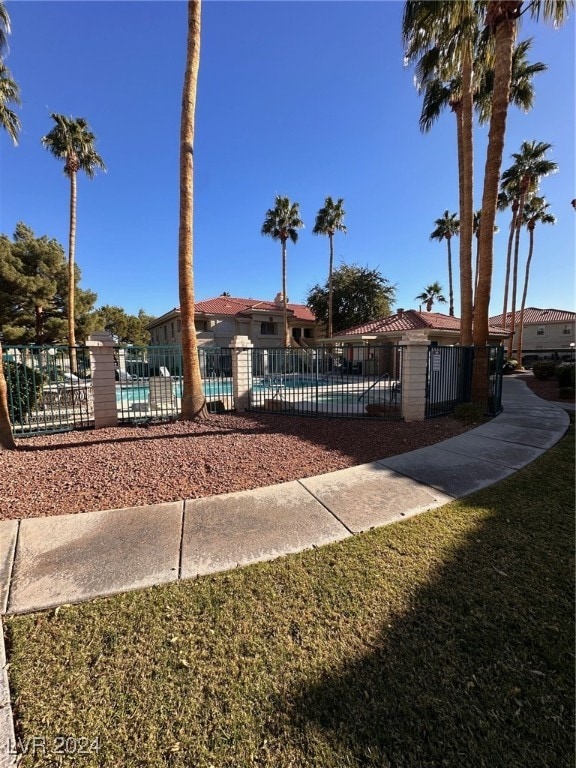 view of front of property with a front lawn and a community pool