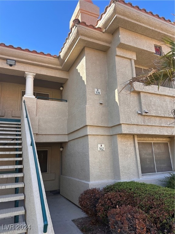 view of exterior entry with a balcony