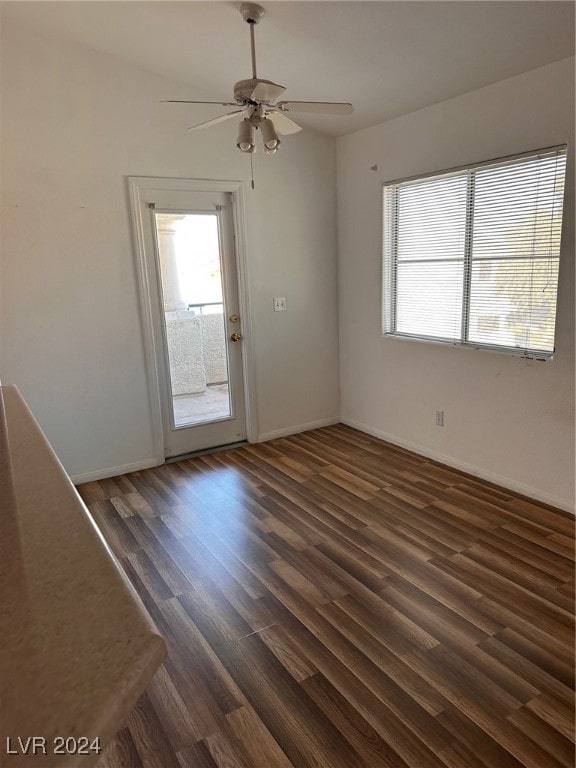 spare room featuring ceiling fan and dark wood-type flooring