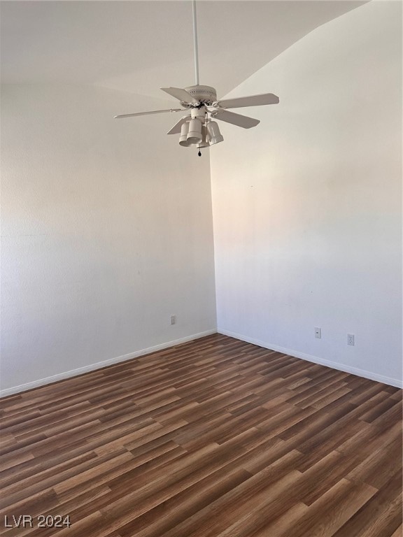 unfurnished room featuring ceiling fan, dark wood-type flooring, and lofted ceiling