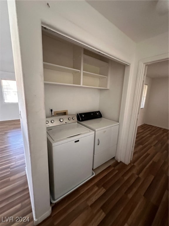 laundry room with washer and dryer and dark hardwood / wood-style floors