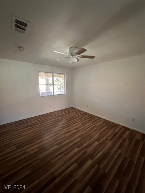 unfurnished room featuring dark hardwood / wood-style floors and ceiling fan