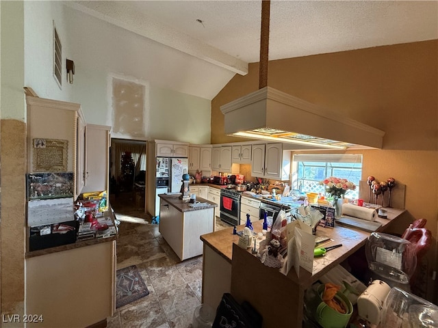 kitchen featuring beamed ceiling, gas range, kitchen peninsula, and high vaulted ceiling