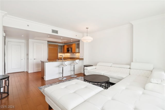 living room with ornamental molding and light hardwood / wood-style flooring