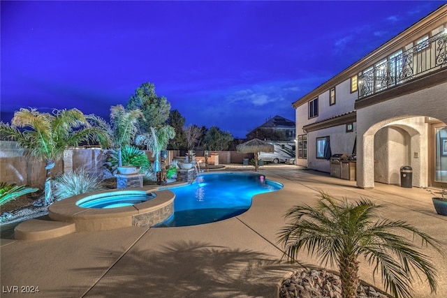 pool at dusk featuring an in ground hot tub and a patio