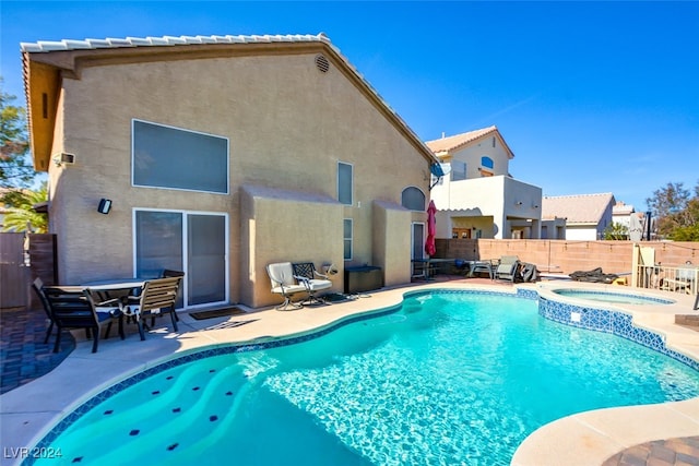 view of pool with a patio area and an in ground hot tub