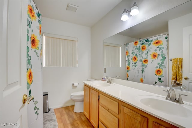 bathroom featuring hardwood / wood-style flooring, vanity, and toilet