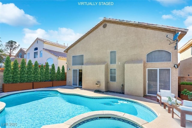 view of pool with an in ground hot tub and a patio