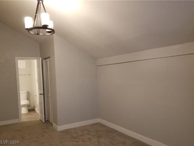 bonus room with lofted ceiling, carpet floors, and a chandelier