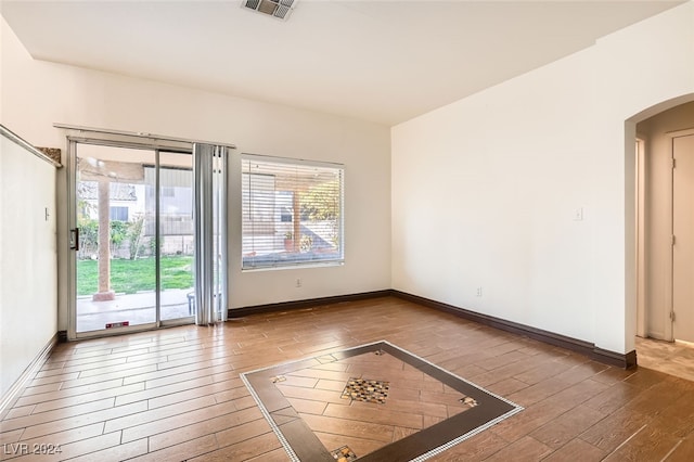 empty room with hardwood / wood-style flooring