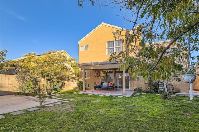 back of house featuring a yard and a patio area