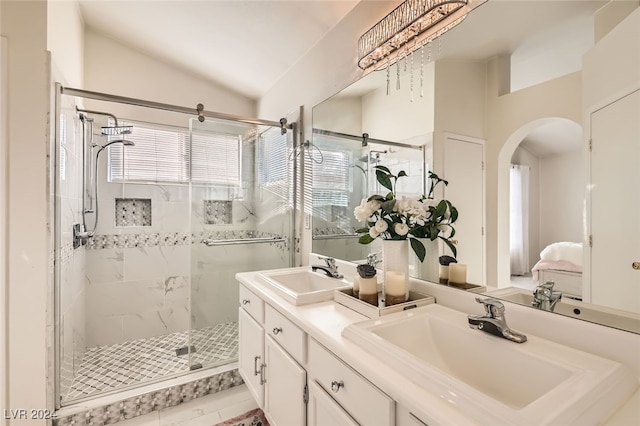 bathroom with tile patterned flooring, vanity, a shower with shower door, and vaulted ceiling