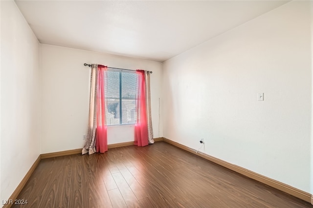 empty room with hardwood / wood-style flooring