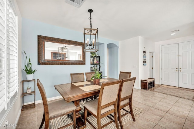 dining space with a notable chandelier and light tile patterned flooring