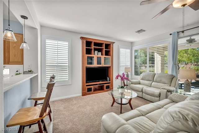 living room with light carpet and ceiling fan