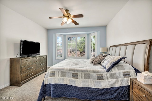 bedroom with ceiling fan and light colored carpet