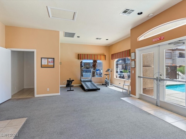 workout area with light carpet and french doors