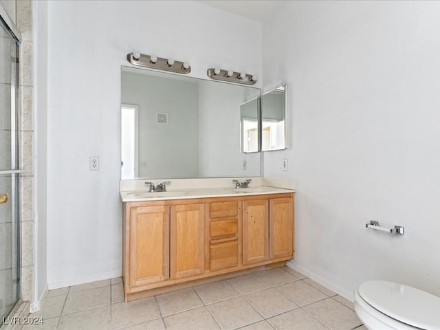 bathroom with tile patterned flooring, vanity, toilet, and a shower with shower door