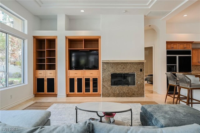 living room with a high ceiling and plenty of natural light