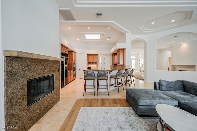 tiled living room with a high end fireplace