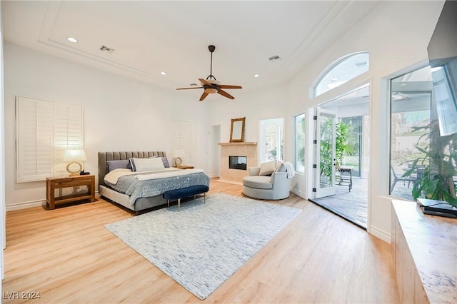 bedroom with ceiling fan, access to exterior, and light wood-type flooring