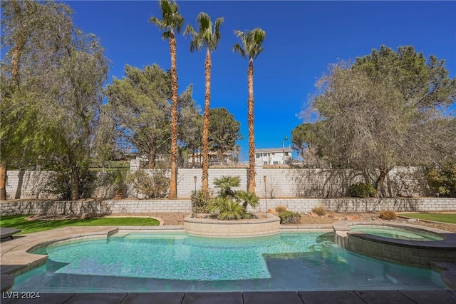 view of pool with an in ground hot tub