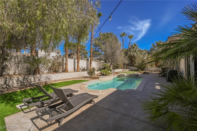 view of pool with a patio and an in ground hot tub