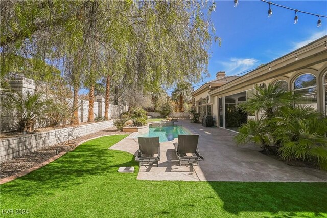 view of yard featuring a fenced in pool and a patio