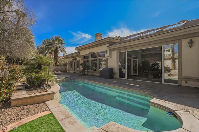 view of swimming pool with a grill and a patio