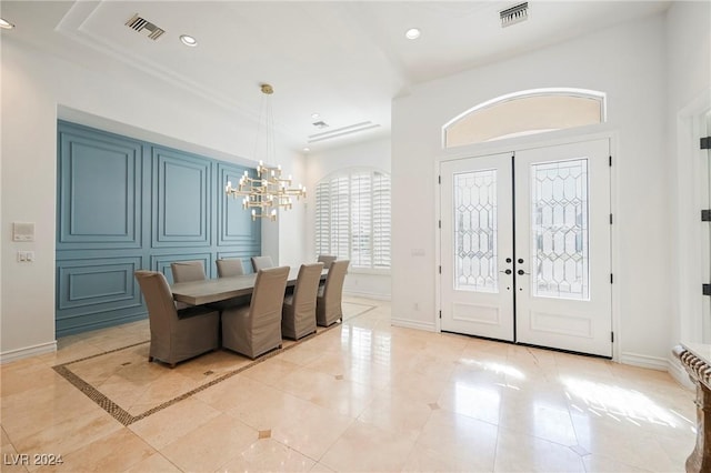 dining room featuring light tile patterned flooring, crown molding, an inviting chandelier, and french doors