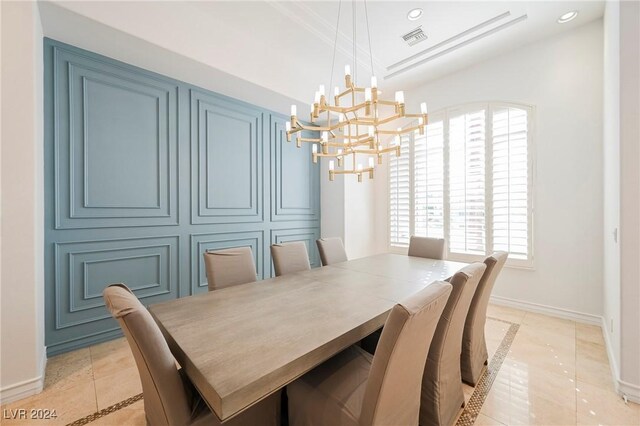 tiled dining room with an inviting chandelier