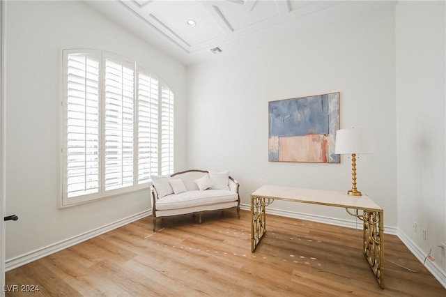 sitting room with beamed ceiling, wood-type flooring, and coffered ceiling