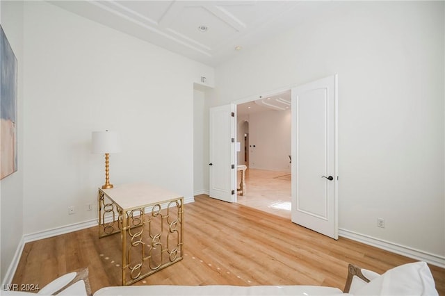 interior space featuring coffered ceiling and wood-type flooring