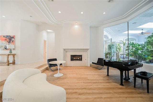 living area featuring light hardwood / wood-style floors and ceiling fan