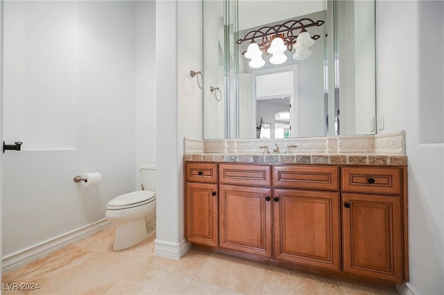 bathroom featuring tile patterned floors, vanity, and toilet