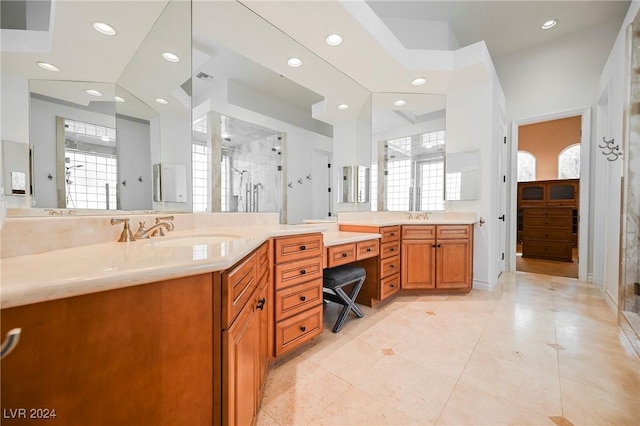 bathroom featuring vanity, a towering ceiling, tile patterned floors, and tiled shower