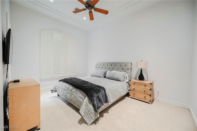 carpeted bedroom with ceiling fan and ornamental molding