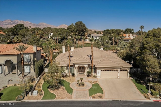 view of front of home featuring a mountain view and a garage