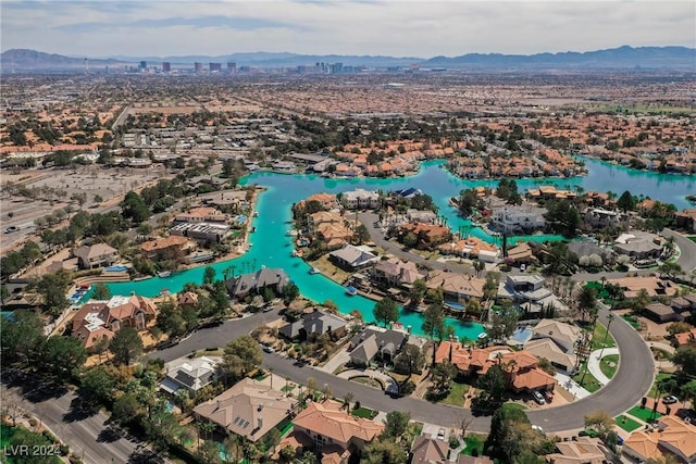 birds eye view of property featuring a water and mountain view