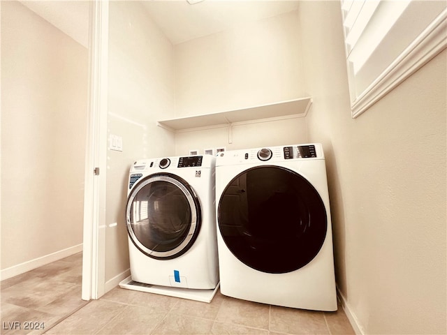 washroom with washer and dryer and light tile patterned flooring