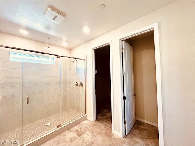 bathroom featuring a shower with door