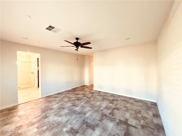 spare room with ceiling fan and wood-type flooring