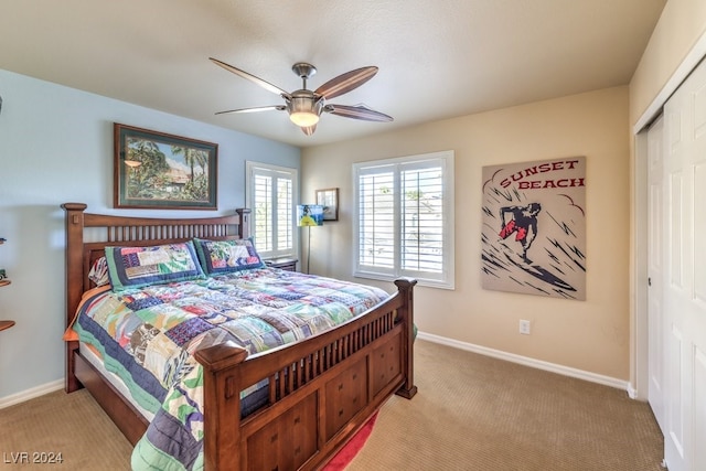 carpeted bedroom featuring ceiling fan and a closet