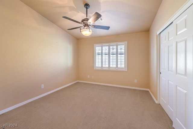 unfurnished bedroom with ceiling fan, a closet, and carpet