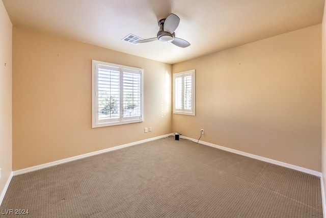 spare room featuring carpet flooring and ceiling fan