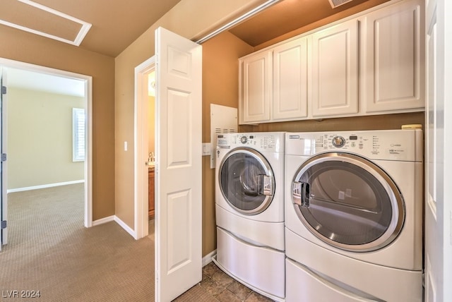 clothes washing area featuring washing machine and clothes dryer, carpet flooring, and cabinets