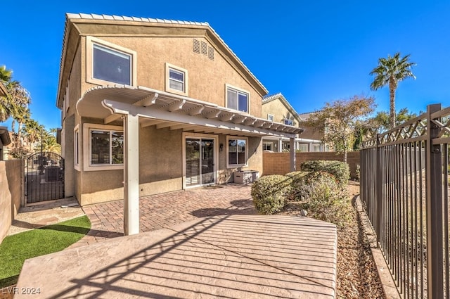 rear view of house featuring a patio